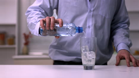 Man-pouring-water-into-a-glass-