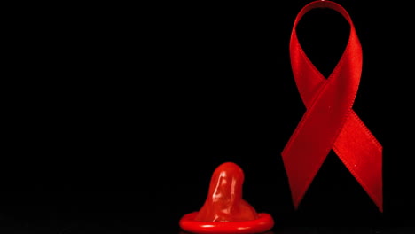 Condom-dropping-down-in-front-of-a-red-ribbon