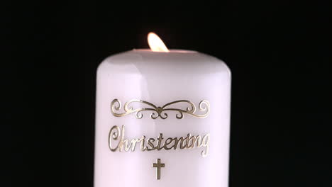 Lit-christening-candle-flickering