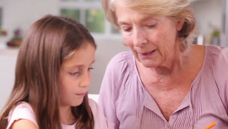 Child-drawing-and-speaking-with-her-granny