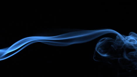 Blue-smoke-blowing-across-black-background