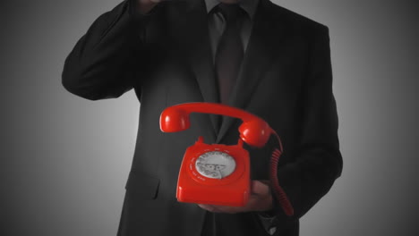 Man-dropping-down-red-phone-receiver-on-dial-phone