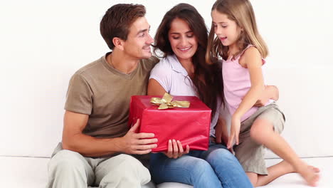 Mother-and-father-getting-gift-from-child