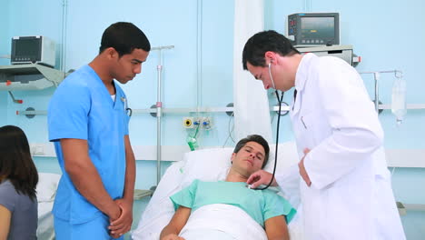 Unsmiling-patient-with-male-nurse-and-doctor