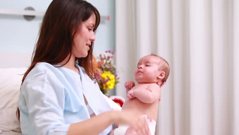 Smiling-mother-holding-a-baby