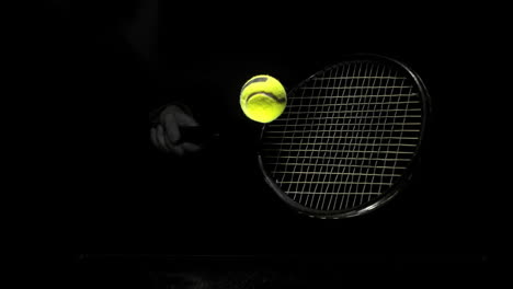 Someone-hitting-tennis-ball-with-racket-on-black-background