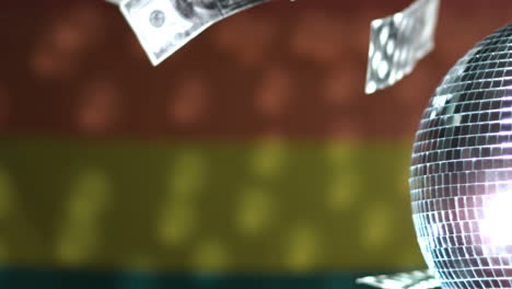 Dollars-falling-against-rainbow-flag-with-spinning-disco-ball