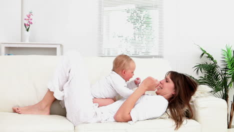 Baby-sitting-on-a-woman-and-she-playing-with-him