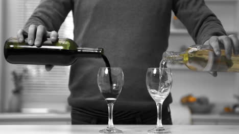 Man-pouring-red-and-white-wine-into-two-glasses