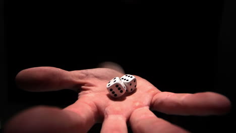 Hands-grasping-white-dice
