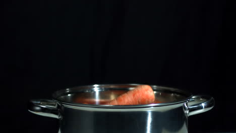 Carrots-falling-into-saucepan
