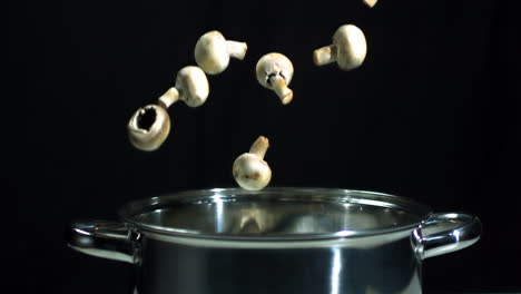 Mushrooms-falling-into-saucepan