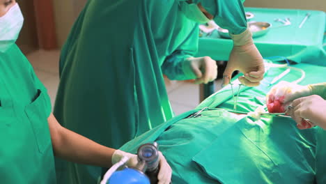 Surgeons-working-on-a-patient-with-a-resuscitation-bag
