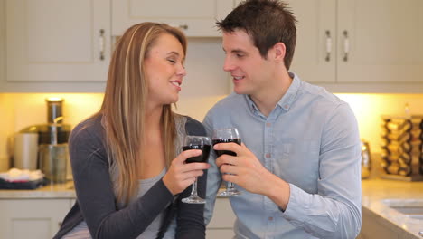 Couple-sitting-in-the-kitchen-drinking-wine