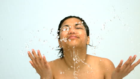 Happy-woman-splashing-water-on-her-face-