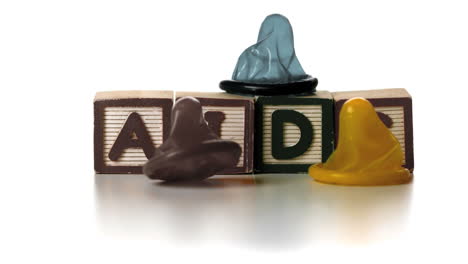 Three-condoms-falling-on-blocks-spelling-AIDS