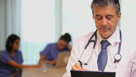 Close-up-of-doctor-with-clipboard