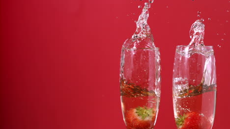 Strawberries-falling-into-champagne-flutes