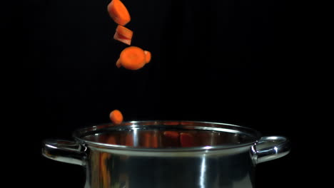 Chopped-carrots-falling-into-saucepan