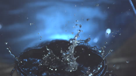 Medicine-jar-falling-into-blue-water-