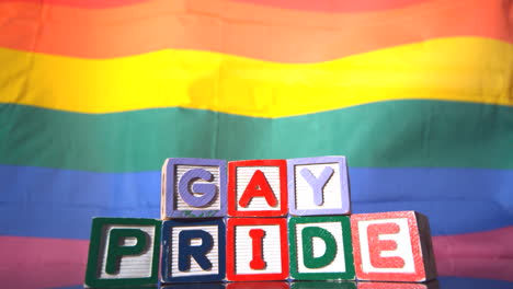 Rainbow-flag-moving-in-the-breeze-with-gay-pride-blocks-in-front