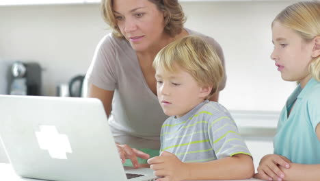 Mother-and-children-using-laptop-