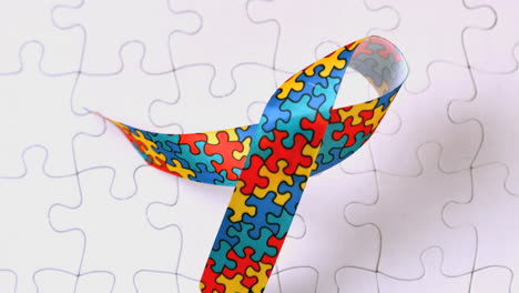 Autism-ribbon-falling-onto-jigsaw-surface