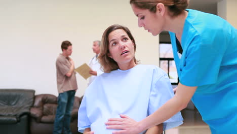 Female-doctor-wheeling-a-pregnant-patient