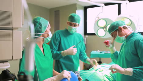 Female-anesthetist-holding-a-resuscitation-bag-on-the-face-of-a-patient