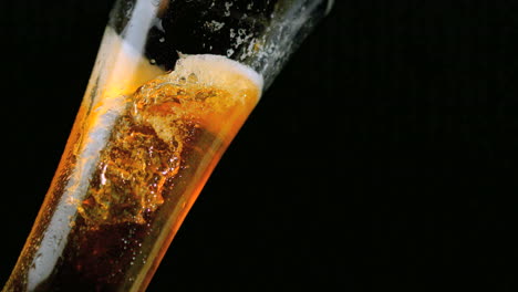 Beer-pouring-into-glass-on-black-background