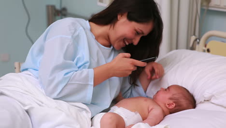 Mother-taking-a-picture-of-a-newborn-baby