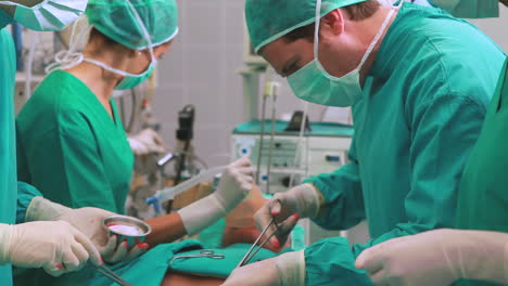 Group-of-surgeon-operating-an-unconscious-patient-in-an-operating-theater