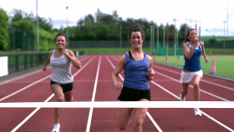 Three-athletes-running-towards-the-finish-line