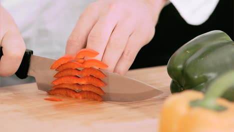 Woman-cutting-a-bell-pepper-in-slow-motion