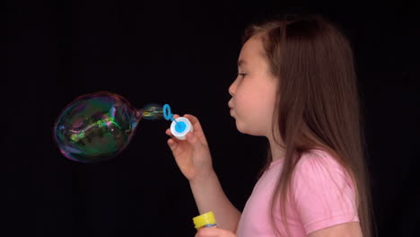 Cheerful-girl-making-big-bubbles