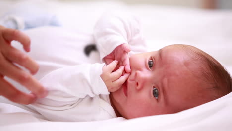 New-born-baby-in-diapers-lying-on-a-bed-with-blankets