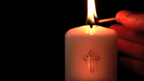 Candle-with-cross-embellishment