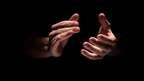 Hands-clapping-on-black-background-close-up