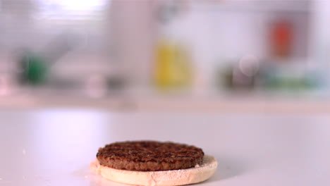 Burger-falling-on-bun-in-kitchen
