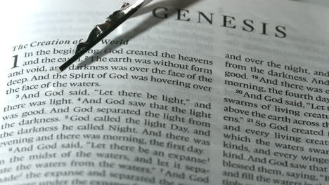 Rosary-beads-falling-onto-book-of-genesis