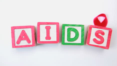 Aids-spelled-out-in-blocks-with-red-ribbon