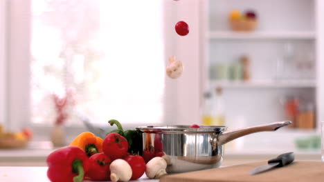 Cherry-tomatoes-and-mushrooms-falling-in-saucepan-in-kitchen