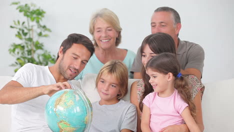 Mehrgenerationenfamilie-Blickt-Auf-Den-Globus