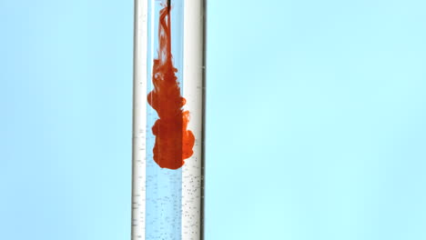 Syringe-injecting-blood-in-test-tube-of-water