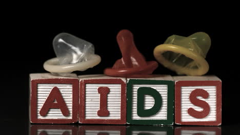 Coloured-condoms-falling-on-blocks-spelling-aids