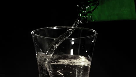 Bottle-pouring-fizzy-water-into-glass-