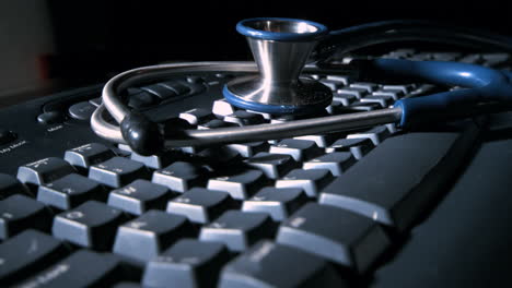 Stethoscope-falling-onto-computer-keyboard-and-bouncing
