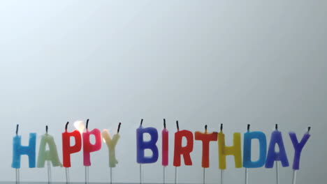 Colourful-happy-birthday-candles-being-blown-out