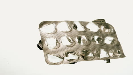 Empty-blister-pack-of-tablets-falling-and-hovering-mid-air