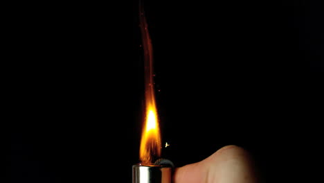 Hand-lighting-lighter-with-large-flame-and-sparks